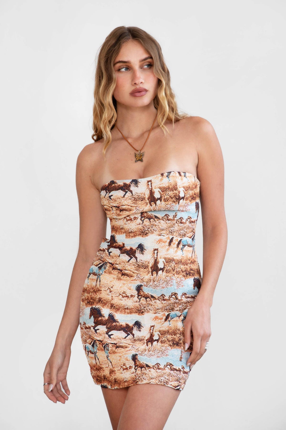Women's western mini dress featuring vintage horse print and strapless fitted silhouette