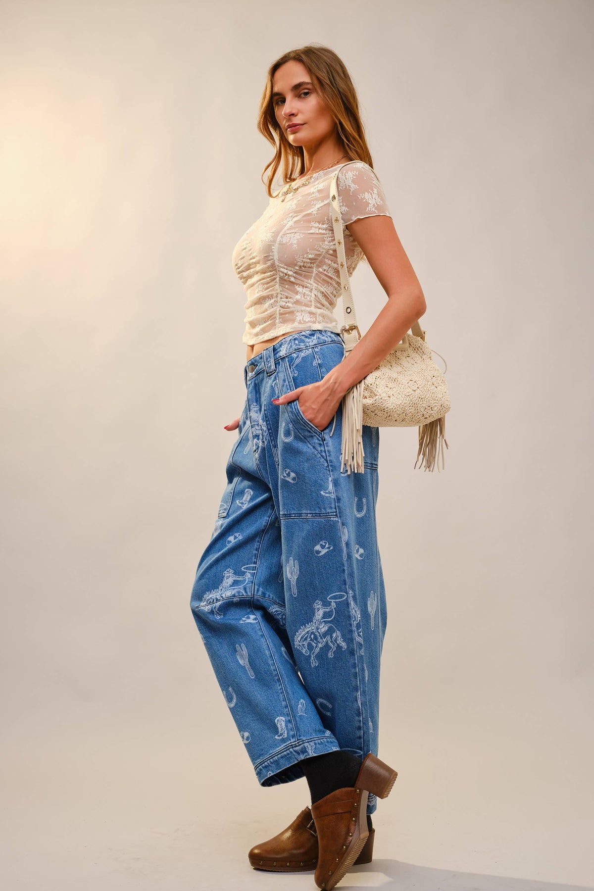 Texas inspired barrel jeans showcasing horseshoes,cacti and rodeo graphic premium denim