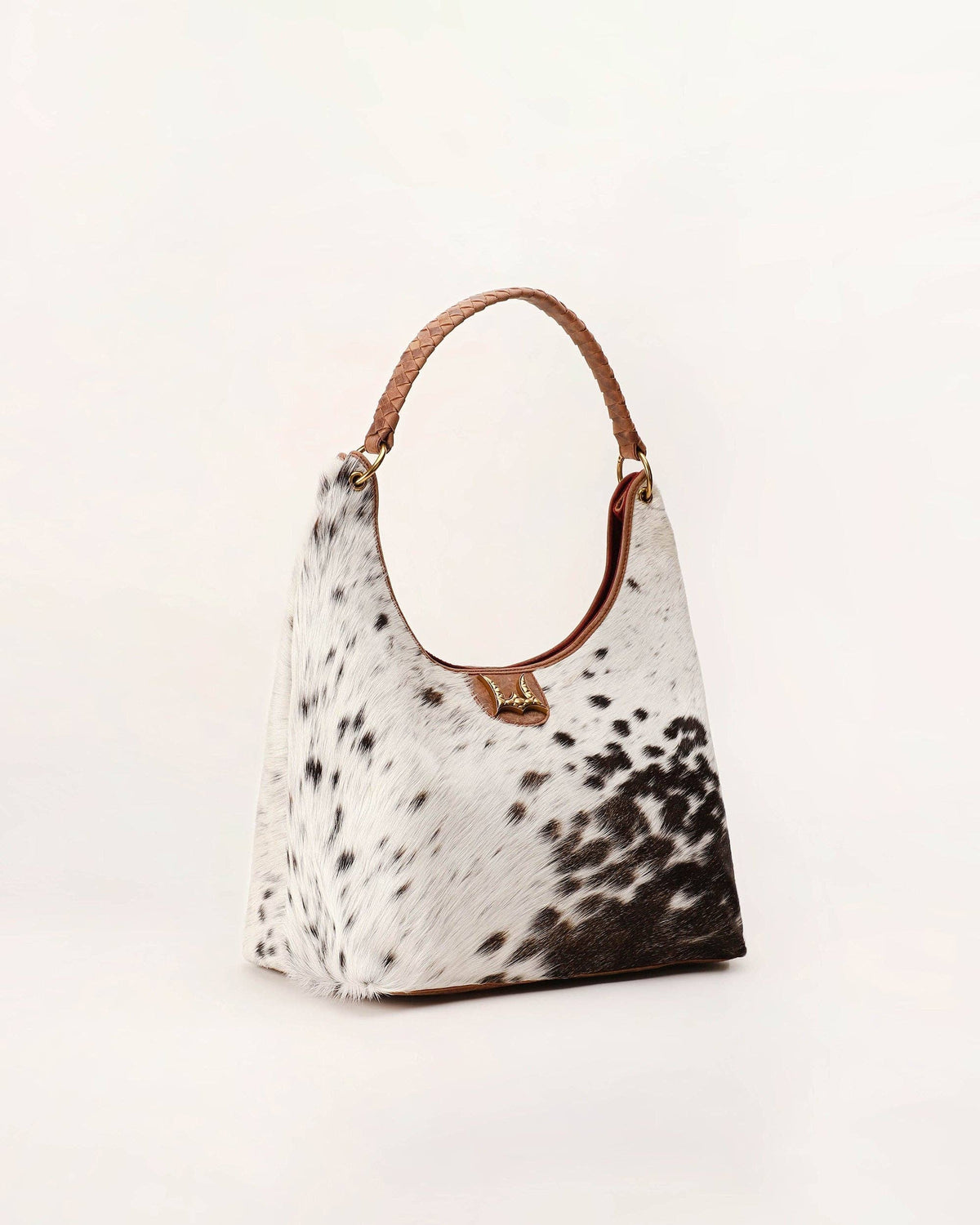Hobo bag with cow print pattern on a light background
