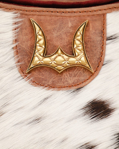 Gold emblem on a leather patch with fur background