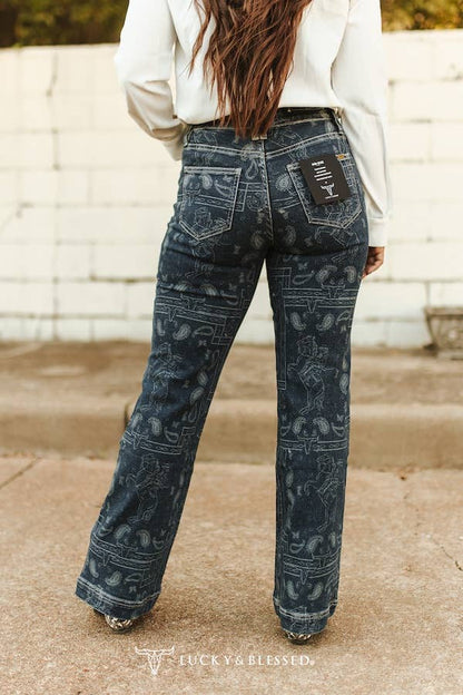 Dark blue Texas brand jeans featuring cowboy rider artwork and western paisley detailing.