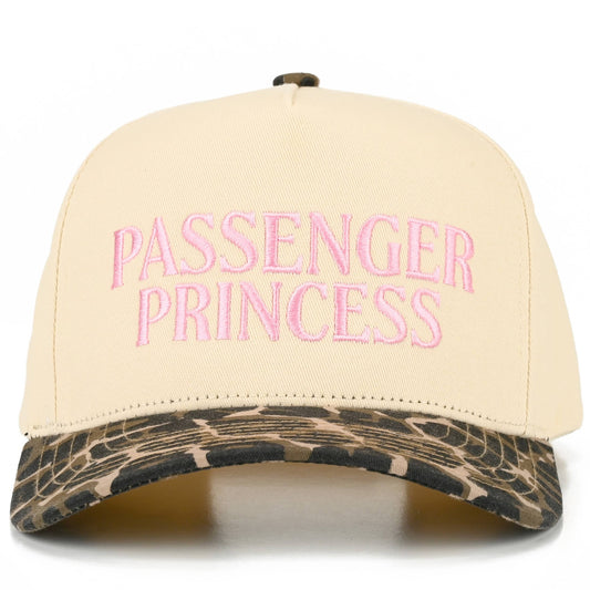 Front view of cream five-panel trucker cap featuring pink embroidered “Passenger Princess” lettering, playful stitched detailing, bold leopard print curved brim, and fun feminine western-inspired styling.