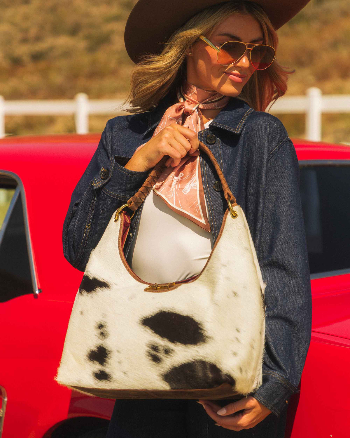 Natural brown and white cowhide handbag with antique gold hardware