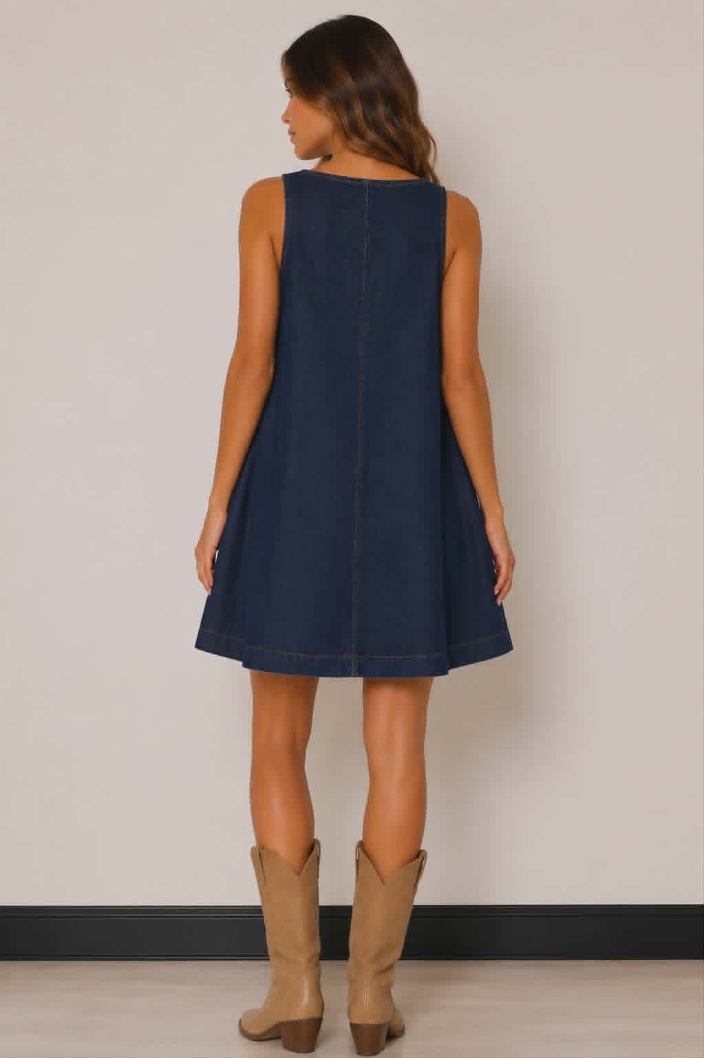 Relaxed fit dark wash denim dress with wide shoulder straps, simple clean back detailing and an effortless oversized shape. A versatile western fashion piece for festivals and casual wear