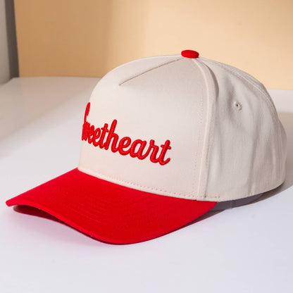 Cap with 'sweetheart' text on a beige background