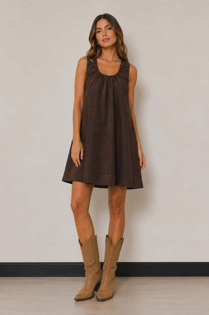 Chocolate brown sleeveless swing dress with relaxed oversized fit, soft gathered neckline and flowy A-line silhouette. Styed with cowboy boots for ultimate western inspired look