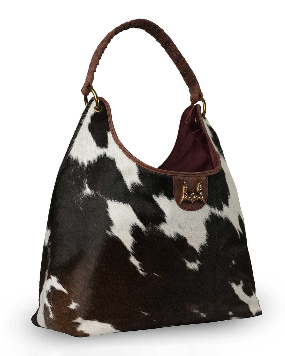 Western cowhide handbag with antique gold hardware, leather handle and unique hide pattern