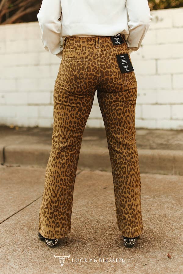 Brown leopard denim jeans with a relaxed straight leg cut, western inspired design, and statement animal print perfect for rodeo season