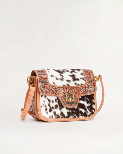 Tan leather and black and white cowhide western shoulder bag with floral tooling by willow wanderers