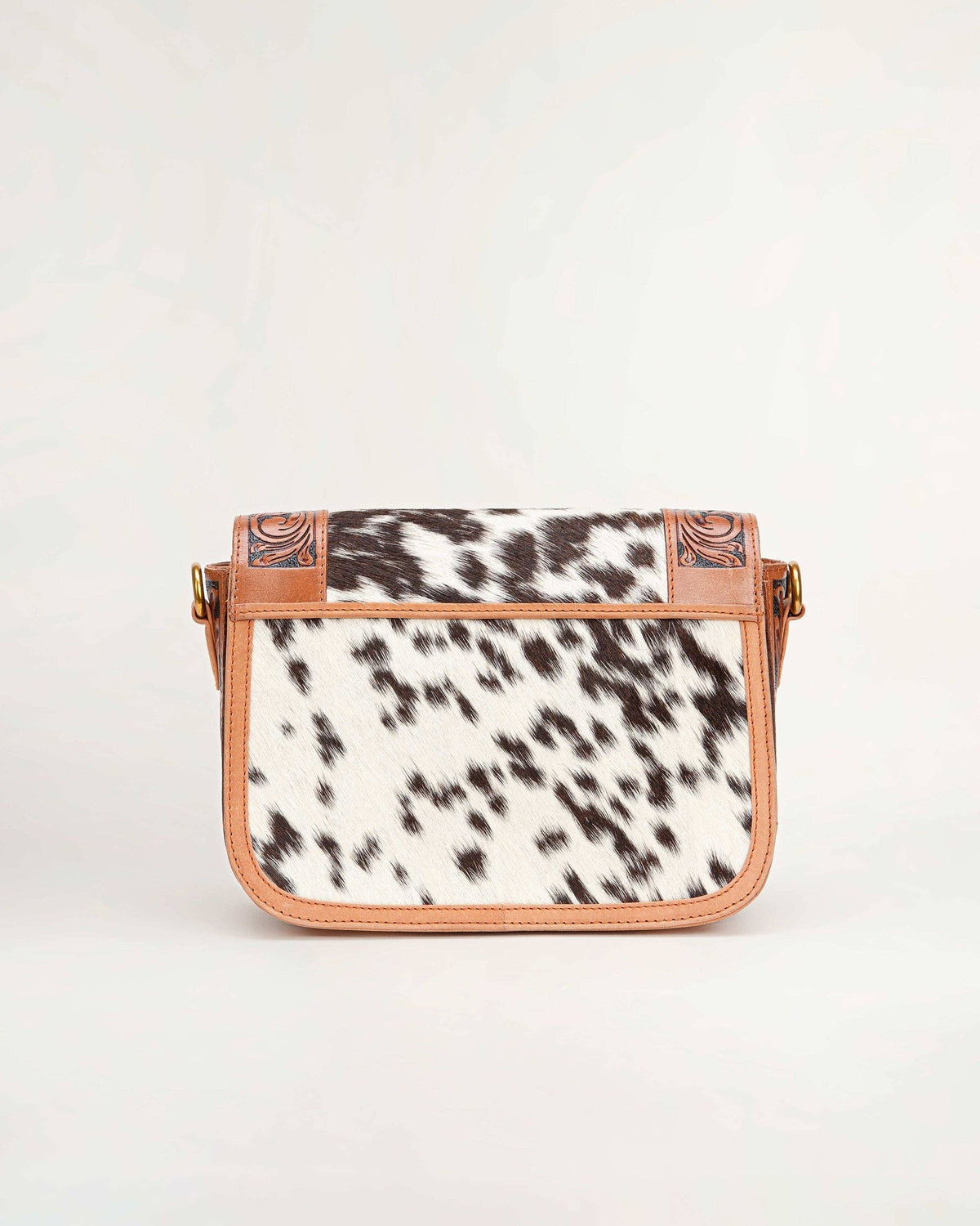 Crossbody bag with cow print pattern on a white background