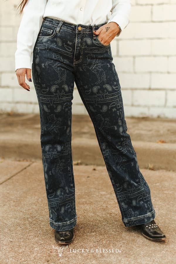 Women's western denim jeans with all over rodeo inspired print and relaxed straight leg fit