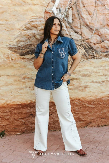 Cream western jeans styled with cowboy boots and a denim shirt
