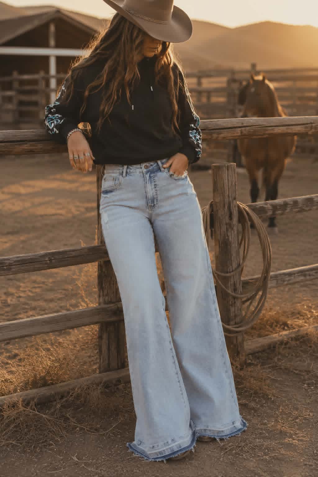 Light wash wide leg stretch denim jeans with mid rise waist and relaxed western inspired fit