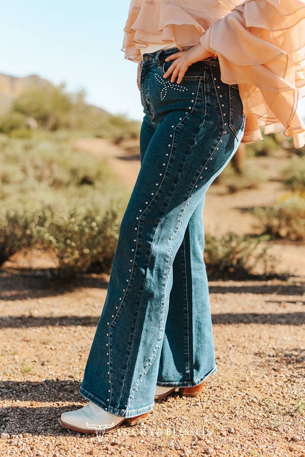 High rise dark denim jeans featuring silver stud embellishments down each leg