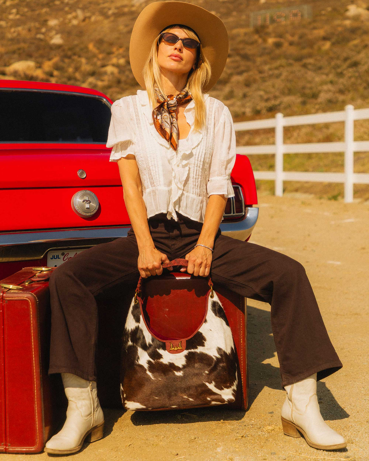 Loyal West western cowhide bag featuring signature gold W logo and natural hair on hide 
