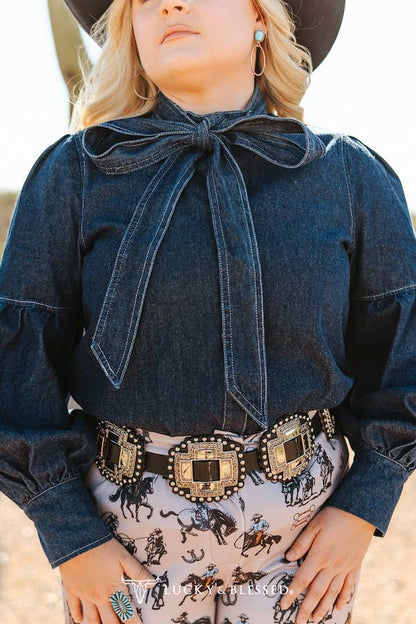 soft structured denim blouse featuring statement balloon sleeves and tie neckline