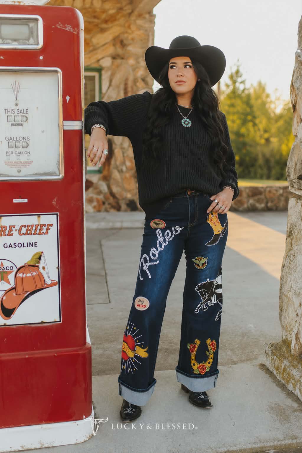 Women's Dark wash western wide leg jeans featuring colourful rodeo inspired embroidered patches paired with a black knit jumper