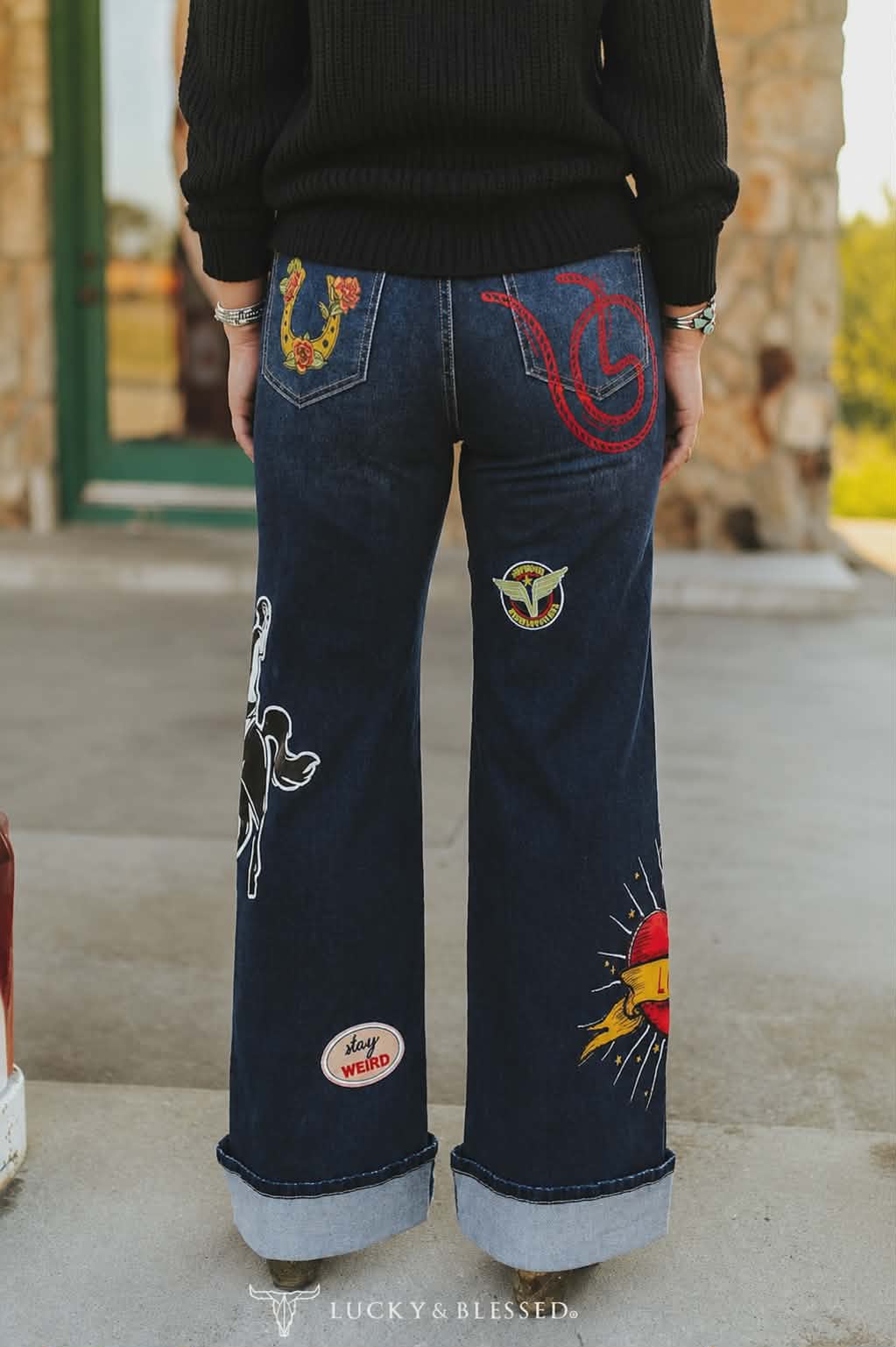 High rise cowgirl jeans with western embroidery including cowboy boots, horseshoes and vintage rodeo graphics