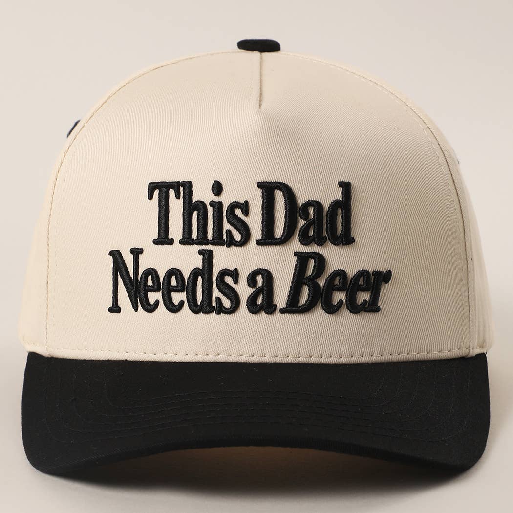Cream and black trucker cap embroidered with " This Dad Needs a Beer"