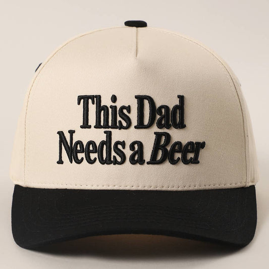 Cream and black trucker cap embroidered with " This Dad Needs a Beer"