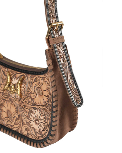 Brown leather handbag with intricate tooled design and gold accents on a white background