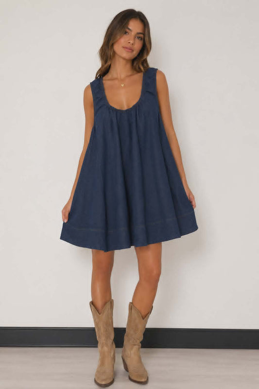 Dark denim swing dress with relaxed A-line fit, sleeveless design and contrast stitching. Easy western inspired mini dress perfect for country concerts, rodeos and everyday styling