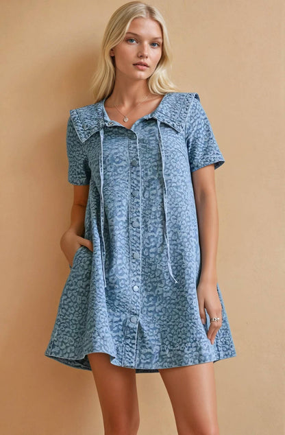 Women's blue leopard print mini dress with oversized collar and button front design.