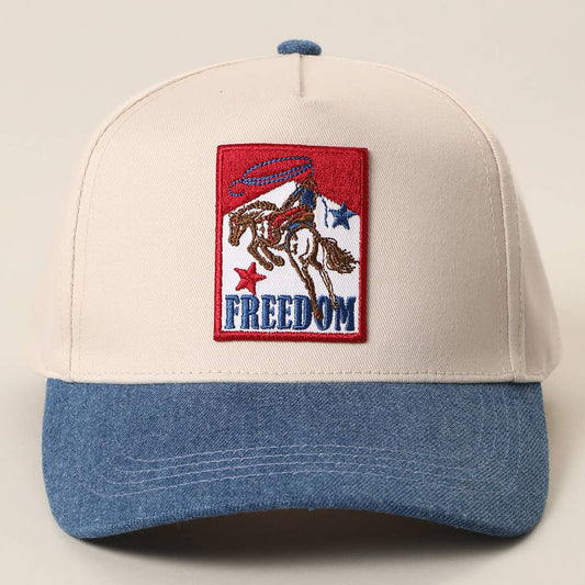 Freedom Rodeo trucker cap with embroidered bucking bronc patch on a cream and blue cap