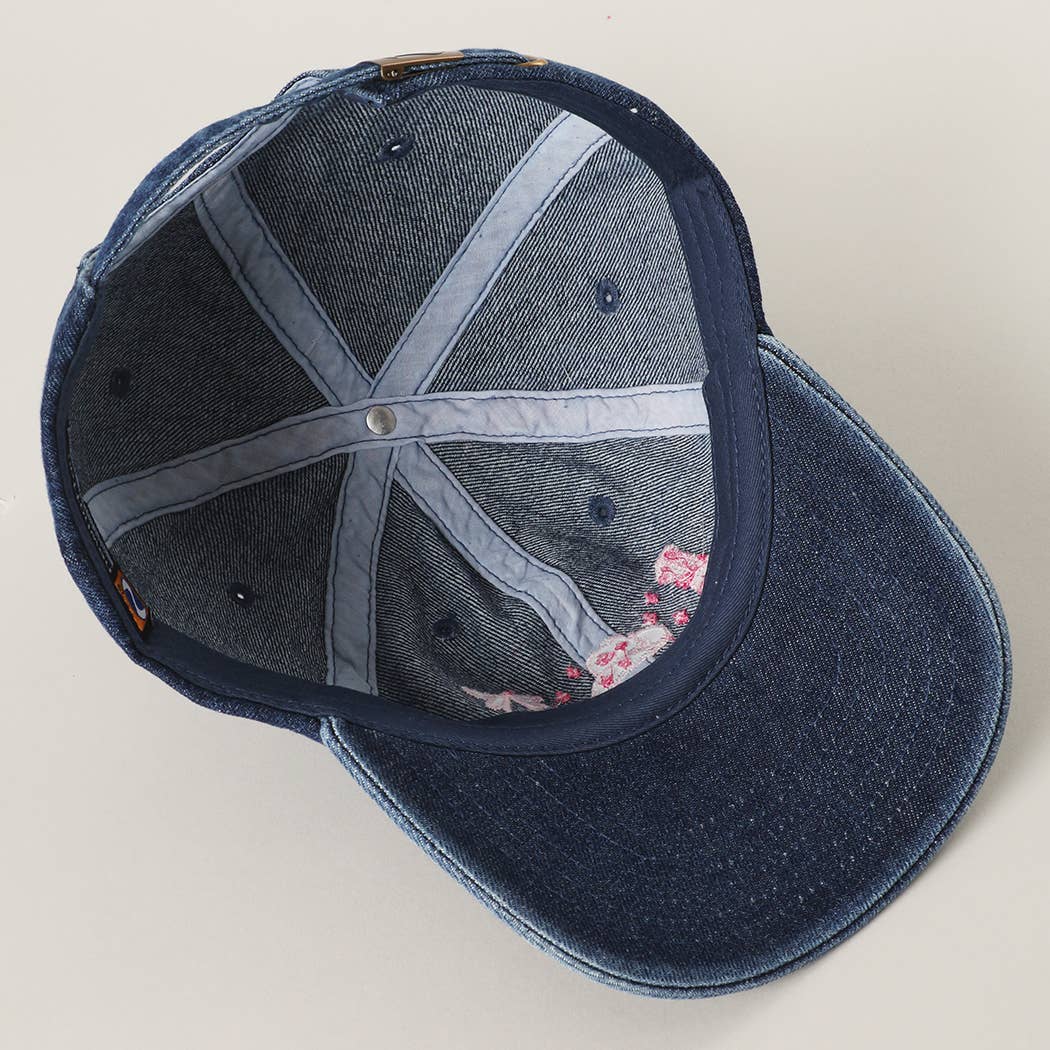 Stylish dark denim trucker cap with cowboy themed embroidery