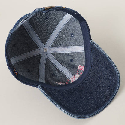 Stylish dark denim trucker cap with cowboy themed embroidery