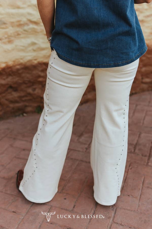 Western boutique ivory denim jeans with rhinestone stud accent