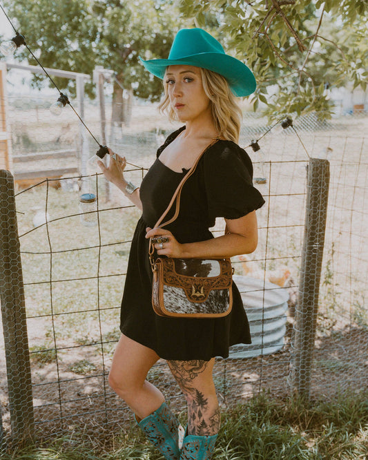 Desert desire Medium bag featuring black and white haor on cowhide, hand tolled floral leather and gold western hardware