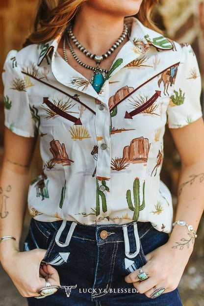 Western cotton pearl snap shirt with desert inspired print, perfect for rodeos, country concerts and everyday wear