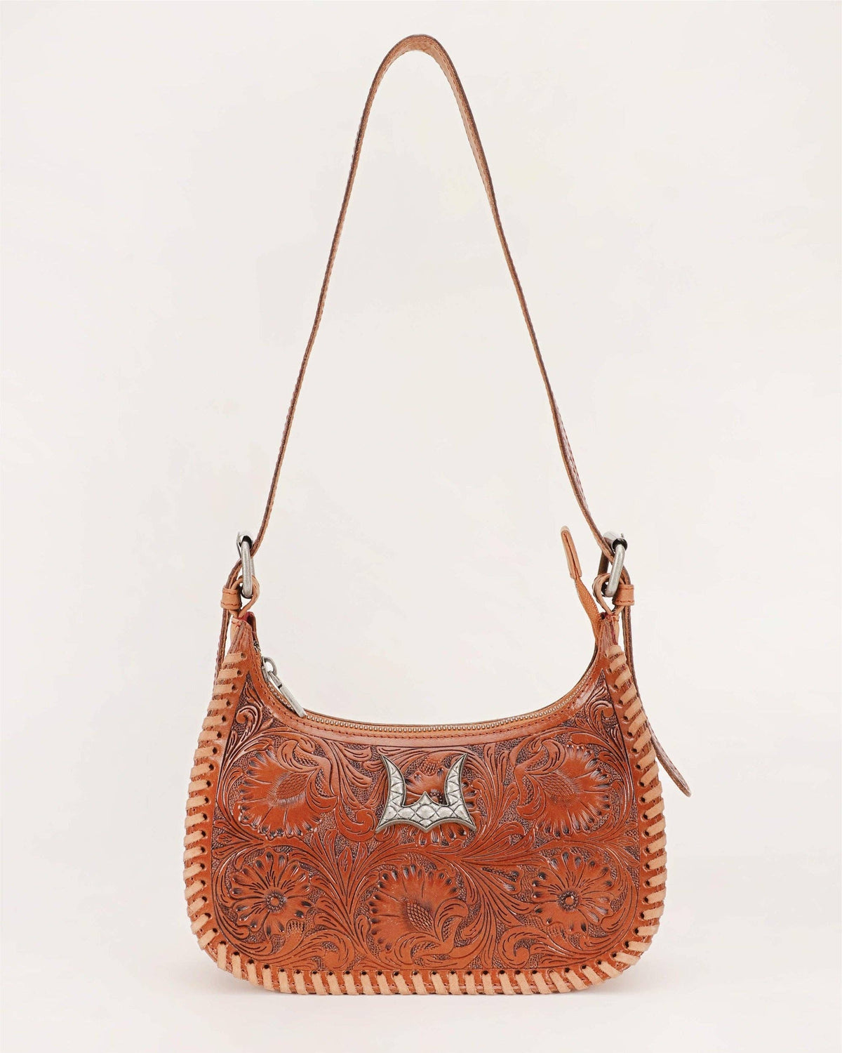 Close up of intricate floral hand tooled leather designed on Dannia western cowgirl handbag