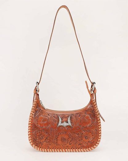 Close up of intricate floral hand tooled leather designed on Dannia western cowgirl handbag
