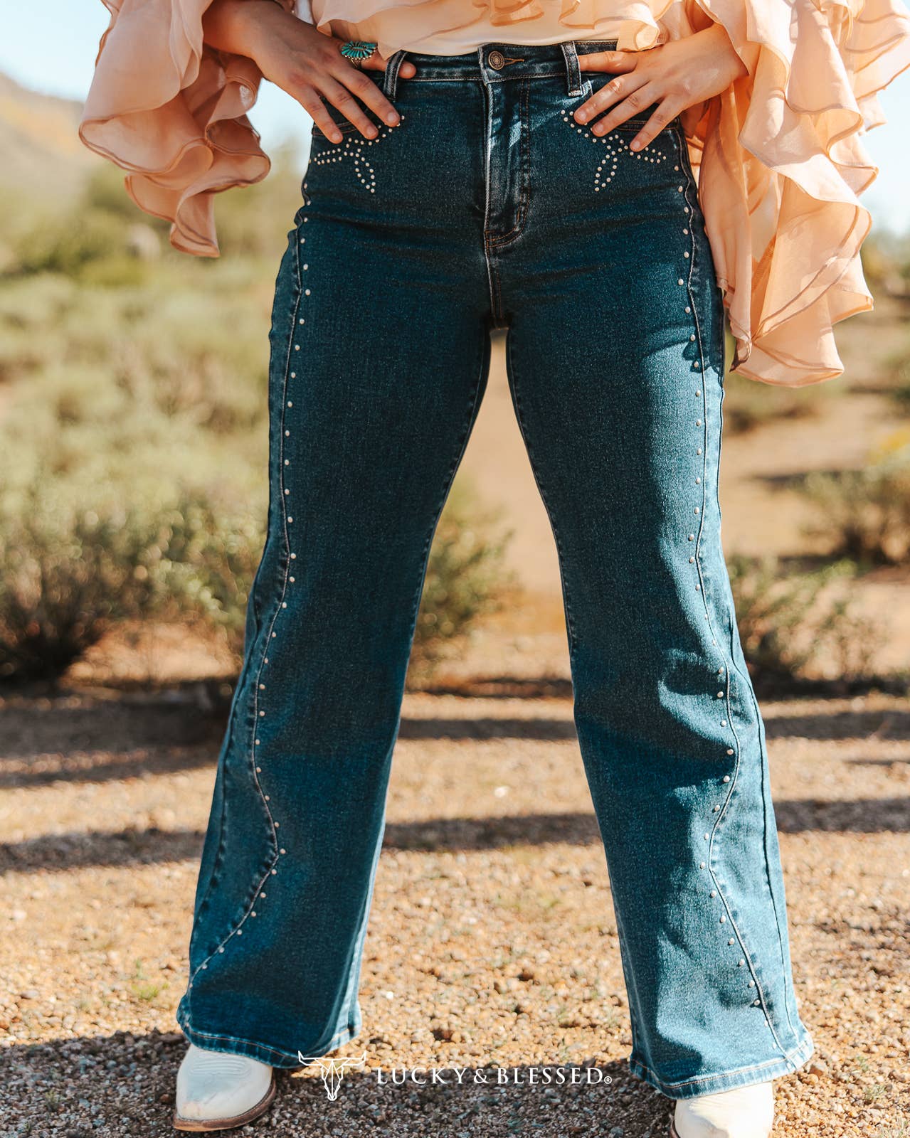 Women's dark wash western jeans with silver stud detailing and bootcut leg