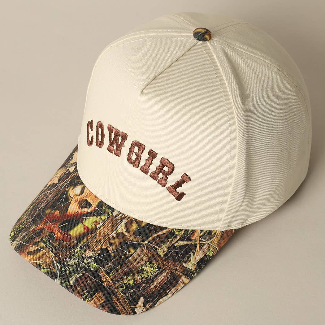 Western snapback cap featuring embroidered Cowgirl text and camouflage brim