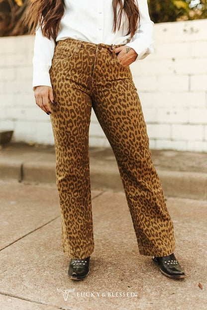 Women’s high-waisted leopard print jeans with straight leg fit, bold western-inspired denim styled with black boots for a country statement look.
