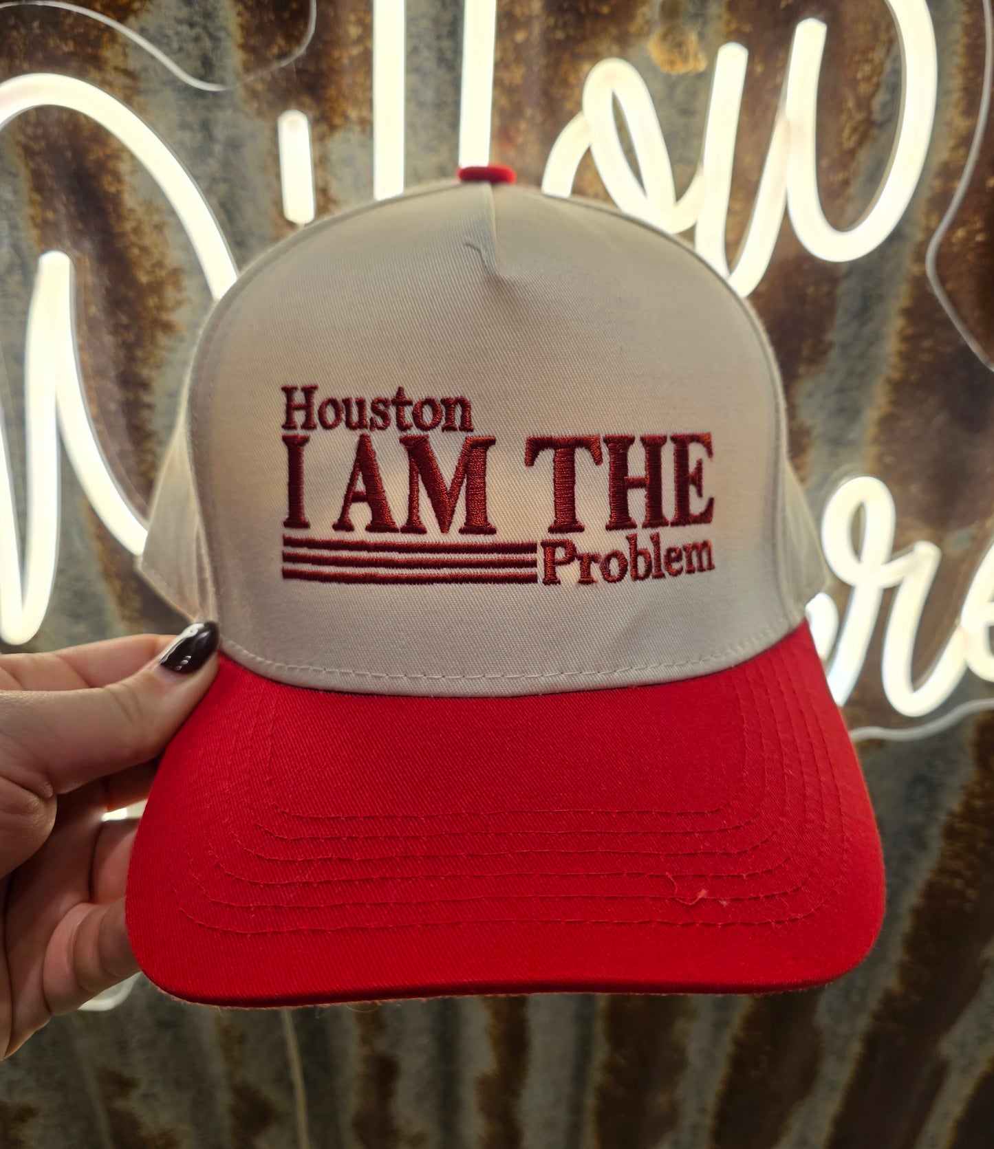 Houston I am The Problem trucker cap with red embroidery and a red brim