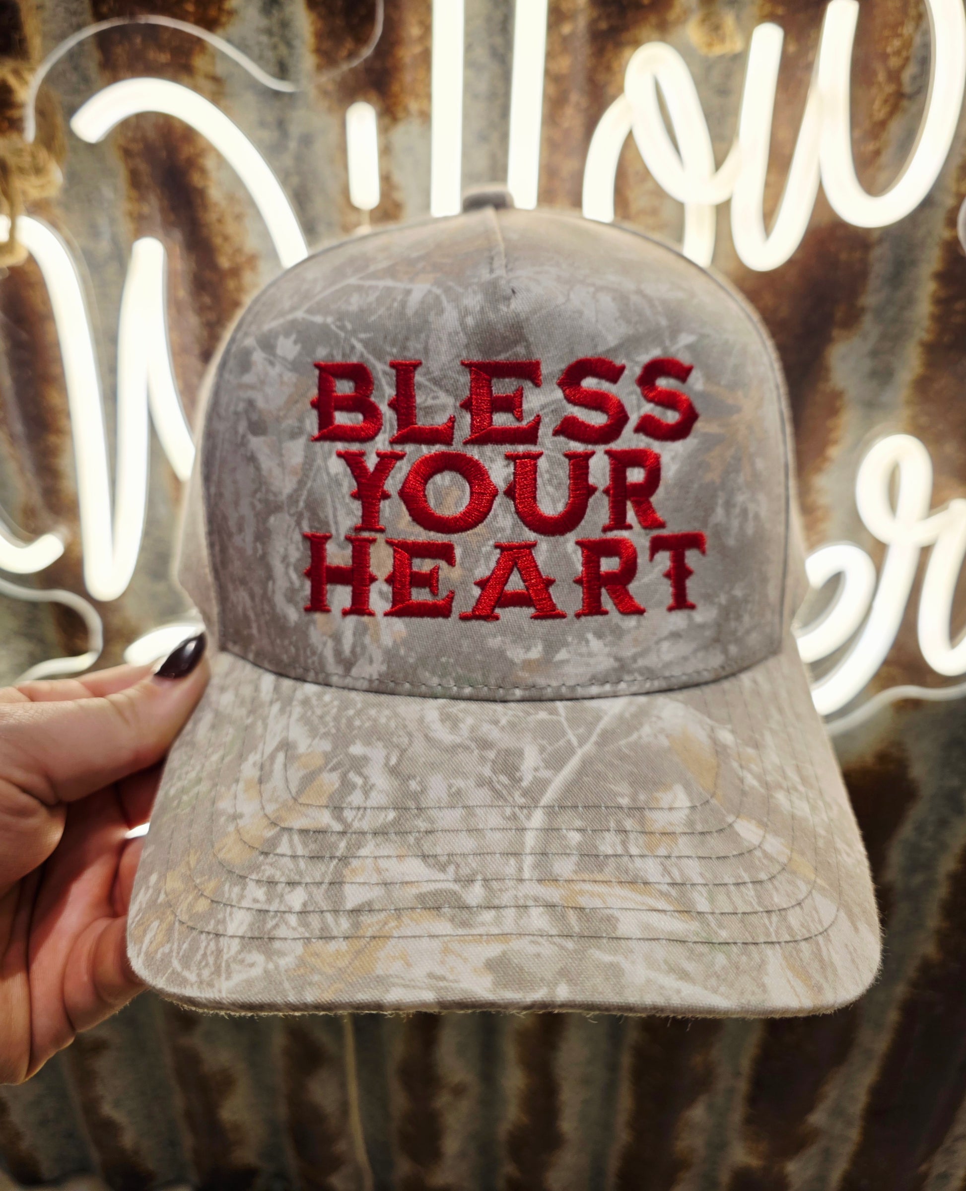 Bless Your Heart cap with red embroidery on soft camouflage fabric