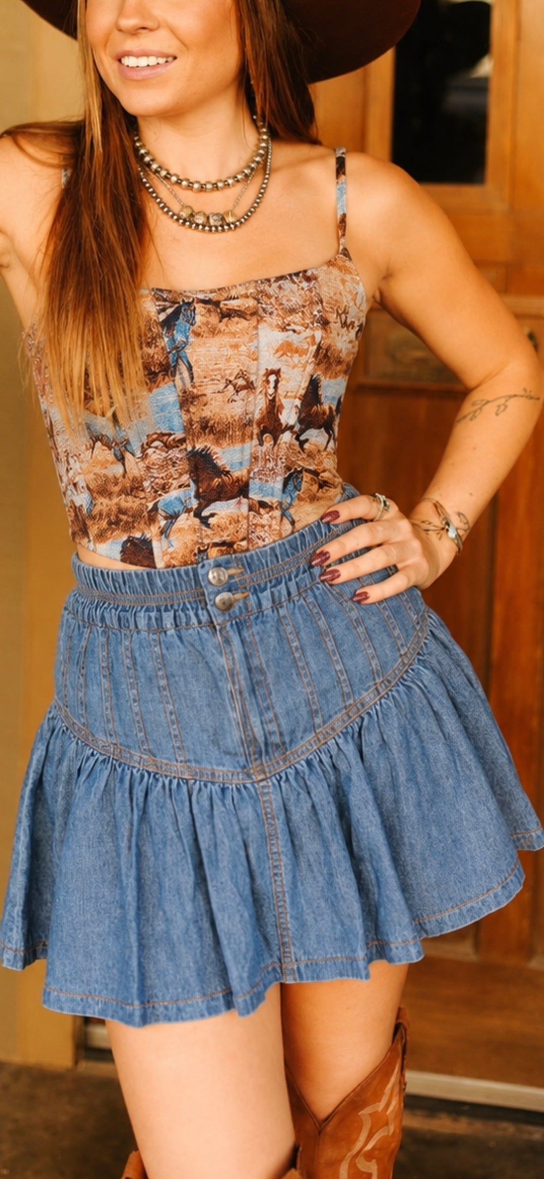 Lightweight western denim skort featuring decorative buttons and a flattering gathered silhouette.