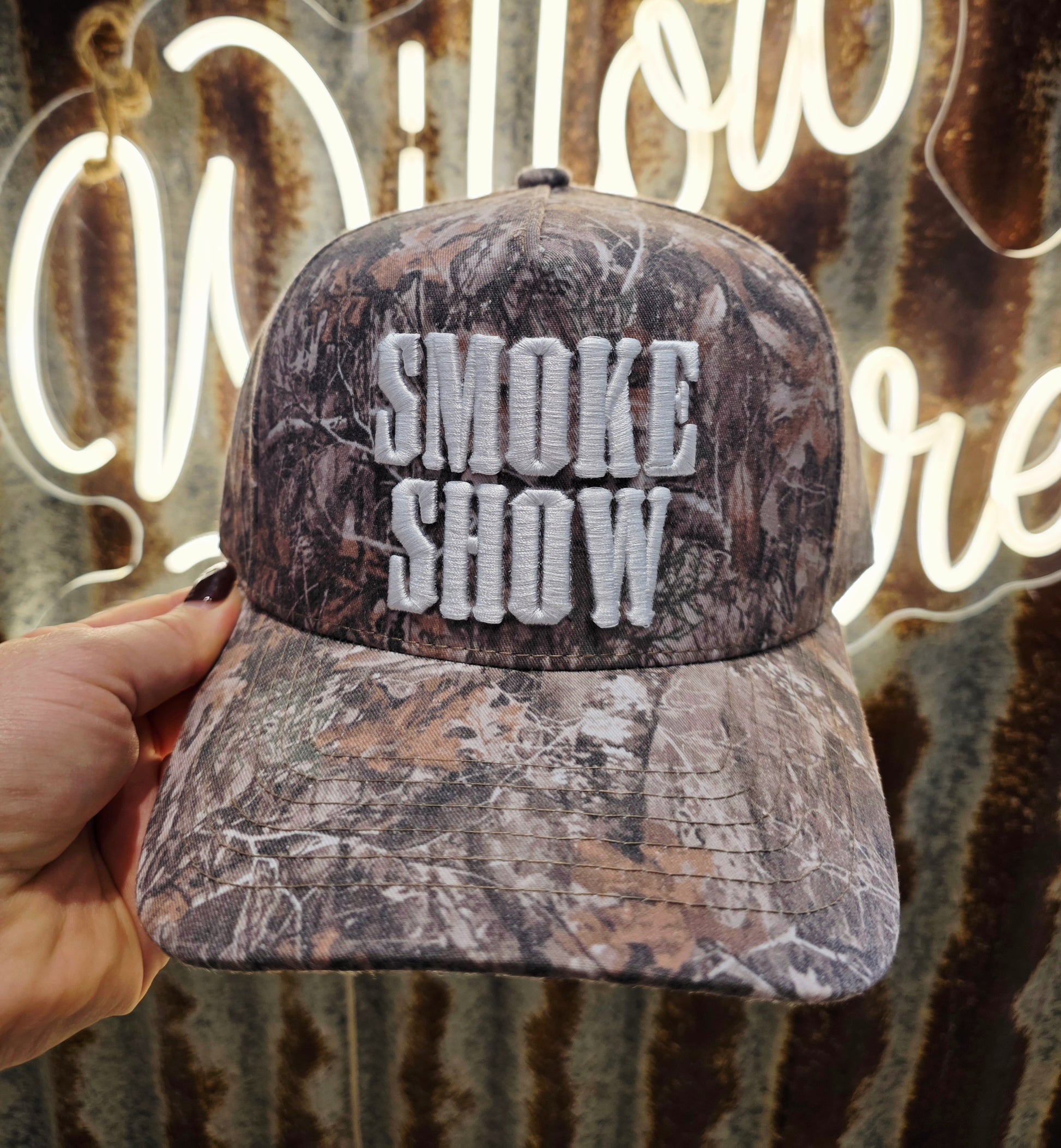 Smoke Show camouflage trucker cap with bold white 3D embroidery